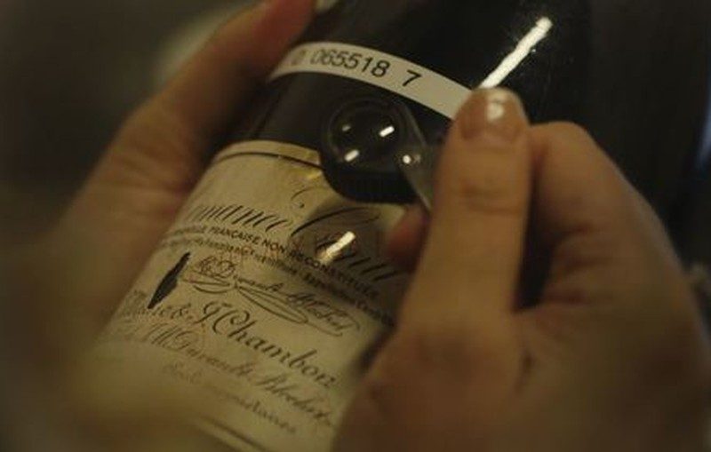 Inspecting a Burgundy label with a loupe